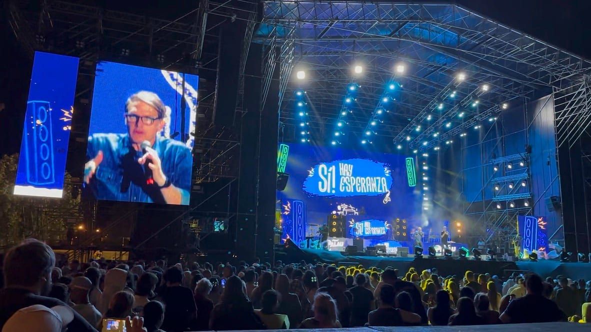 Escenario del Festival Palau Uruguay 2023 de noche, con el lema «Sí, hay esperanza» y el público